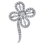A diamond flower brooch/pendant, circa 1955, the stylised flower with knife-edge detailing a...