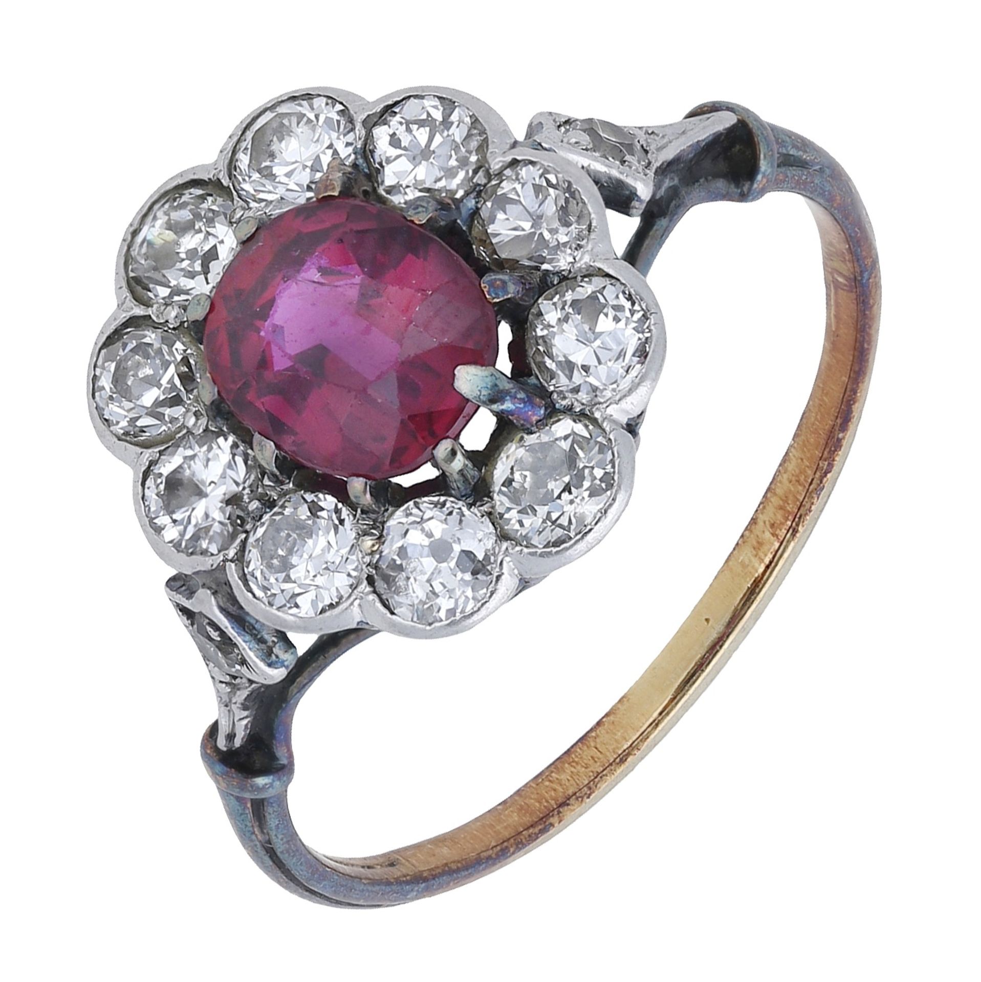 An early 20th century ruby and diamond cluster ring, the oval-cut ruby within a surround of...