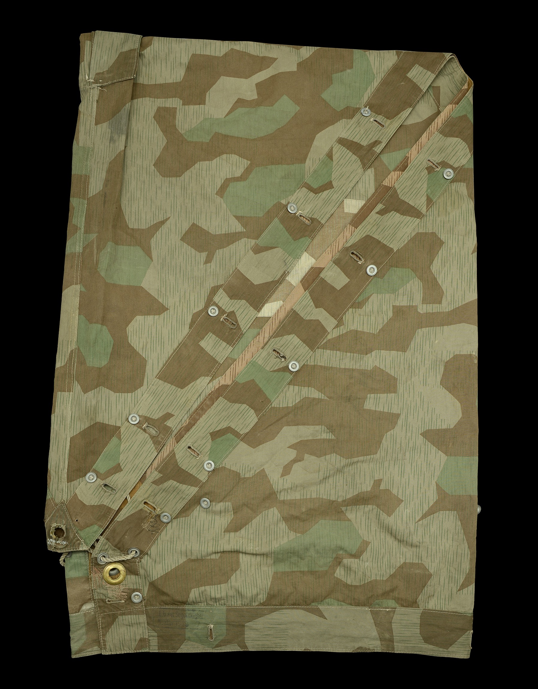 A German Second World War Army Zeltbahn. A splinter pattern camouflage armed forces zeltbah...