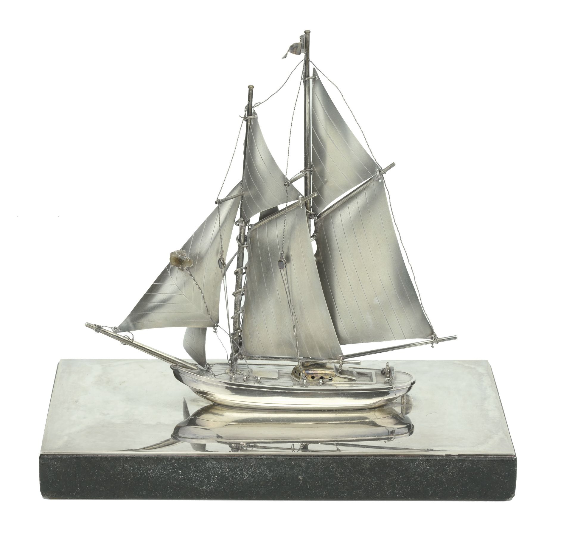 A Japanese silver desk table ornament modelled as a yacht, 20th century, the twin-mas...
