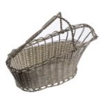 A white metal wirework wine bottle basket, with twist carrying handle and pouring spout, 19c...