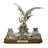 A German silver presentation inkstand, the silver mount modelled as a swooping gull,...