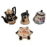 TWO VICTORIAN STAFFORDSHIRE POTTERY IMARI PATTERN TEAPOTS LATE 19TH CENTURY one with a stand, 15cm &