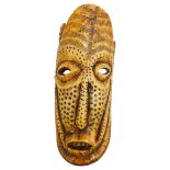 AN AFRICAN IVORY TRIBAL MASK FROM ZAIRE, late 19th century, decorated with drilled roundels and