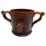 VICTORIAN TWO-HANDLED 'FROG' TANKARD  19TH CENTURY covered in a rich brown-treacle glaze, the