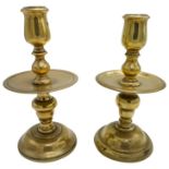 PAIR OF DUTCH HEEMSKERK BRASS TABLE CANDLESTICKS 17TH CENTURY with a domed foot rising to a tulip