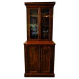 A 19TH CENTURY POLLARDED OAK PANELLED BOOKCASE ON CUPBOARD, the bookcase section comprising of three