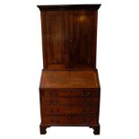 SMALL GEORGE III MAHOGANY BUREAU BOOKCASE CIRCA 1760 the dentil cornice above a pair of panelled