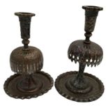 TWO PERSIAN TINNED COPPER CANDLESTICKS 19TH CENTURY  raised on a wide dished circular foot 19cm &