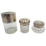 THREE SILVER MOUNTED JARS one Birmingham 1897, the others with rubbed marks 4cm, 5cm & 7.5cm high