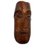 AN AFRICAN IVORY LEGA TRIBE MASK FROM ZAIRE, late 19th century, of plain form, with ovoid eyes and