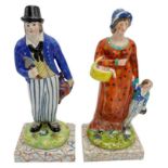 PAIR OF PEARLWARE FIGURES CIRCA 1820 depicting a woodsman, his wife and child, raised on