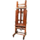 LATE VICTORIAN OAK AND PINE EASEL WINSOR & NEWTON, CIRCA 1900 with a winding handle to adjust both