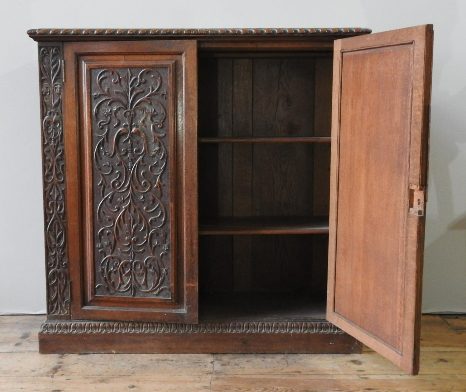 A 19TH CENTURY CARVED OAK TWO DOOR BOOKCASE, the two door panels decorated with foliate carving - Image 6 of 6