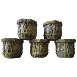 FIVE WEATHERED RECONSTITUTED STONE GARDEN TUBS, decorated with warrior and soldier figures, with a
