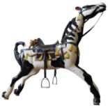 A PAINTED WOODEN ROCKING HORSE, in black and white dappled colours, decorated with American