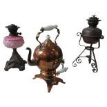 A 19TH CENTURY COPPER SPIRIT KETTLE ON STAND AND TWO OIL LAMPS, including a Victorian cast-iron