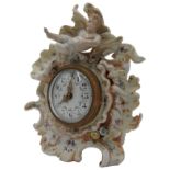 A CONTINENTAL PORECLAIN CASED MANTEL CLOCK, the case decorated cherubs and shells, adorned with hand