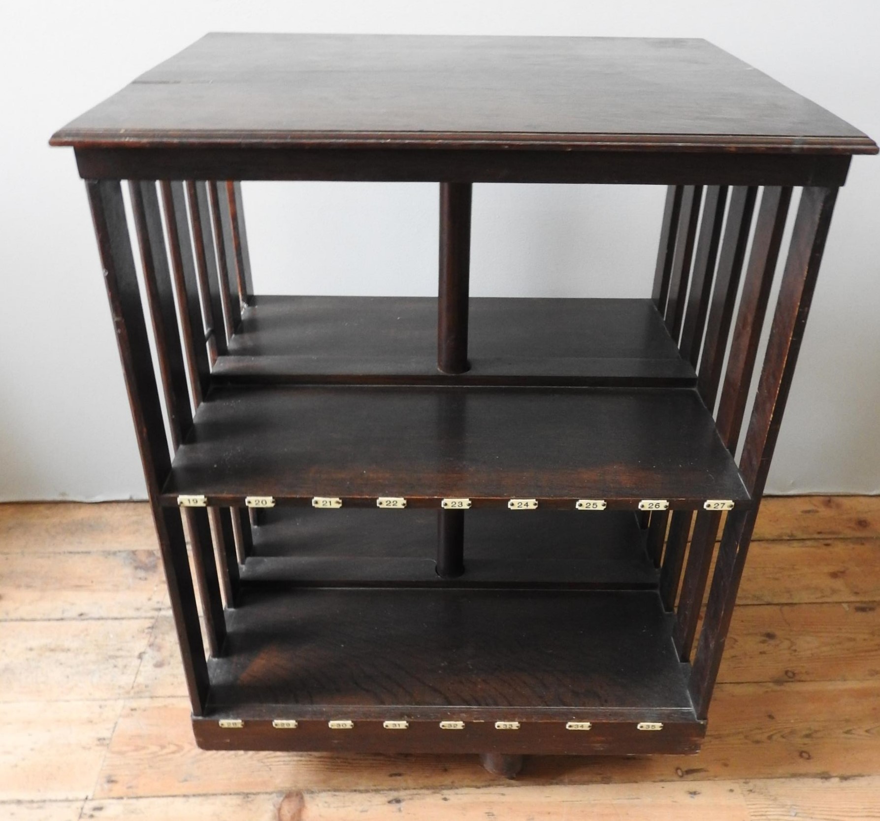 A 1930's OAK REVOLVING TWO TIER LIBRARY BOOKCASE, with original filing labels attached, the - Image 3 of 4