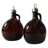 A PAIR OF EARLY 19TH CENTURY AMBER GLASS FLAGON DECANTERS, with silver plated collars and