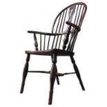 AN EARLY 19TH CENTURY YEW WOOD FRAMED WINDSOR CHAIR, with an elm seat, pierced central splat and