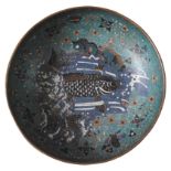 CHINESE CLOISONNE DISH DECORATED WITH A KOI CARP in a frothing pond and foliate motifs, 17cm diam