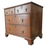 A GEORGE III OAK CHEST OF FOUR DRAWERS, comprising two short drawers over two long drawers, raised