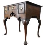 A GEORGE II OAK LOWBOY, circa 1760, one long central drawer and two shorter side drawers, with an