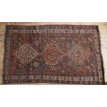 A PERSIAN HAND KNOTTED RUG, a deep border pattern with repeating central motif, orange, fawn, and