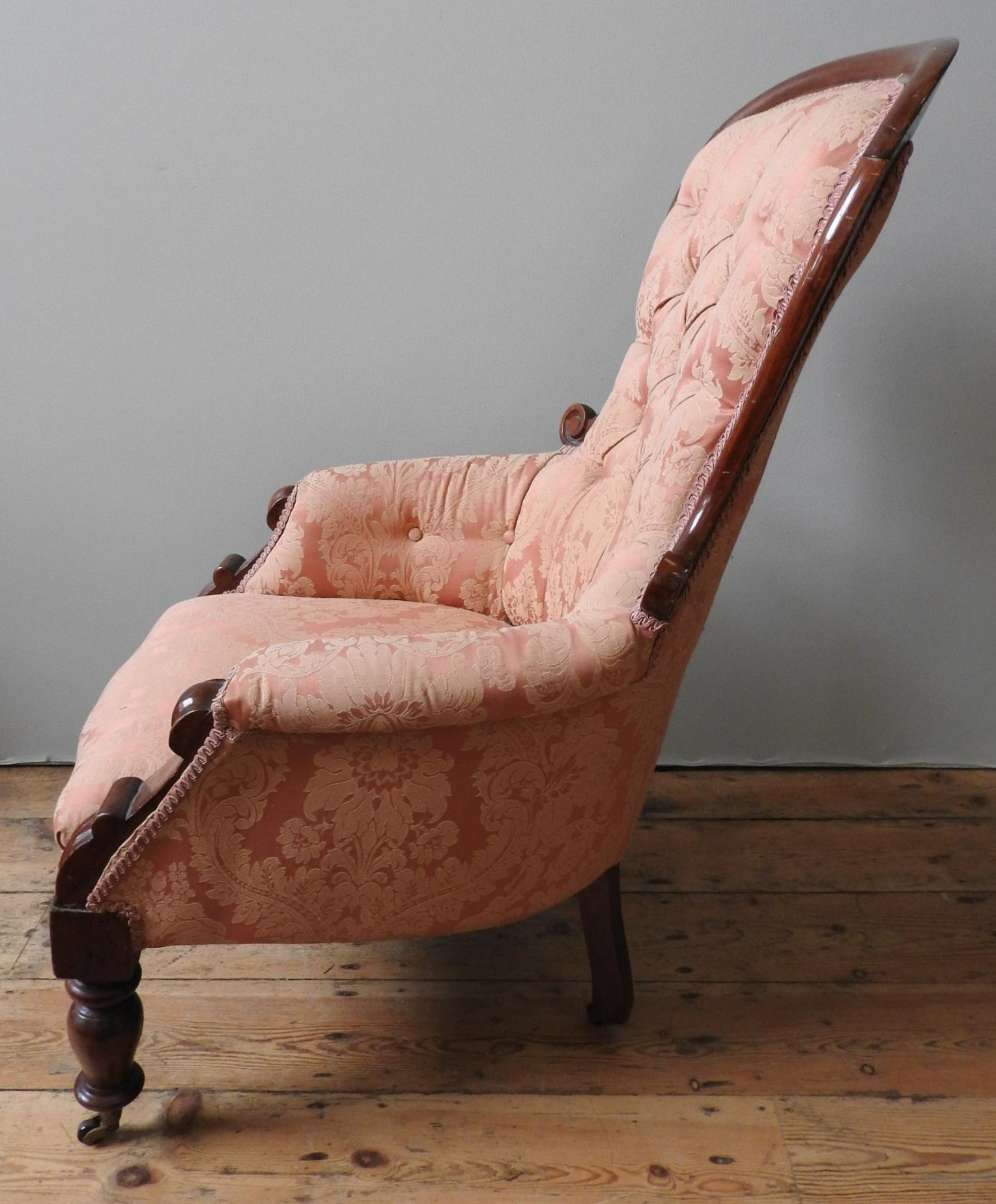 A VICTORIAN MAHOGANY NURSING CHAIR, with scroll carved spoon back, buttoned upholstery supported - Image 4 of 5