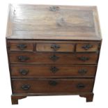 A GEORGE III OAK AND MAHOGANY SIX DRAWER BUREAU, three short drawers over three long drawers, the