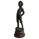 A FRENCH SPELTER FIGURE OF BOY ENTITLED 'SIFFLEUR', signed H. Iremo, mounted on a turned wooden