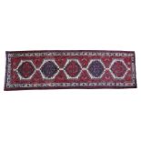 A RED AND CREME MEDALLION PATTERN ARDEBIL RUG, 335 x 105cm