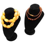 A GRADUATED AMBER BEAD NECKLACE, 46cm, AND AN ELLIPSOID AMBER BEAD NECKLACE, 54cm