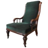 A VICTORIAN MAHOGANY NURSING CHAIR, covered in an emerald green material, , the swept arms supported