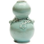 SMALL CELADON-GLAZED DOUBLE GOURD VASE QING DYNASTY, 18TH CENTURY the sides decorated in relief with