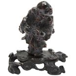 CARVED ROOTWOOD FIGURE  17TH / 18TH CENTURY shown standing holding a ruyi sceptre, raised on a