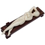 A CHINESE 19TH CENTURY CARVED IVORY FIGURE OF A 'DOCTOR'S LADY', in repose with one arm over her