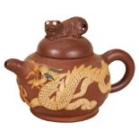 TWO CHINESE YIXING STONEWARE TEAPOTS QING DYNASTY, 19TH CENTURY one decorated in relief with a tiger