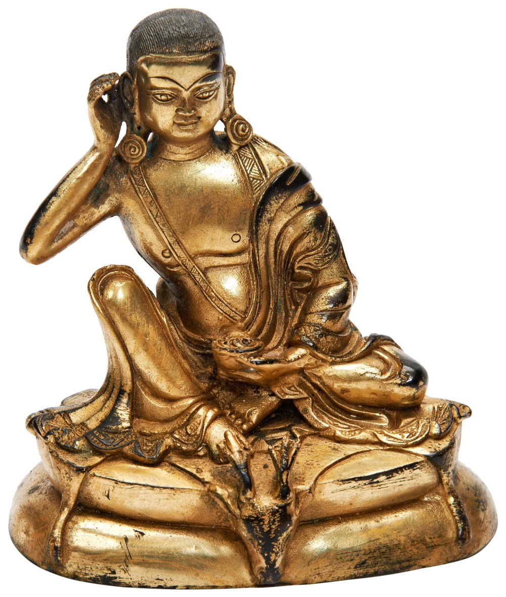 GILT BRONZE FIGURE OF A LAMA 19TH / 20TH CENTURY the figure wearing a long flowing robe open at