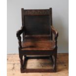 A CHARLES II OAK ARMCHAIR