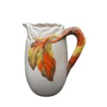 A CLARICE CLIFF NEWPORT POTTERY JUG, moulded branch and leaf design in autumnal tones on a biege