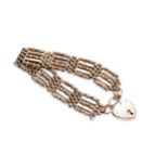 A 9CT GOLD GATE-LINK BRACELET, with heart shaped padlock clasp. Weight 21 grams Marked 9ct