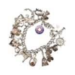 A SILVER CHARM BRACELET, with sixteen assorted charms attached, total weight 72 grams
