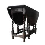 A GEORGE III OAK GATELEG TABLE, with frieze drawer, the folding oval top supported by barley twist