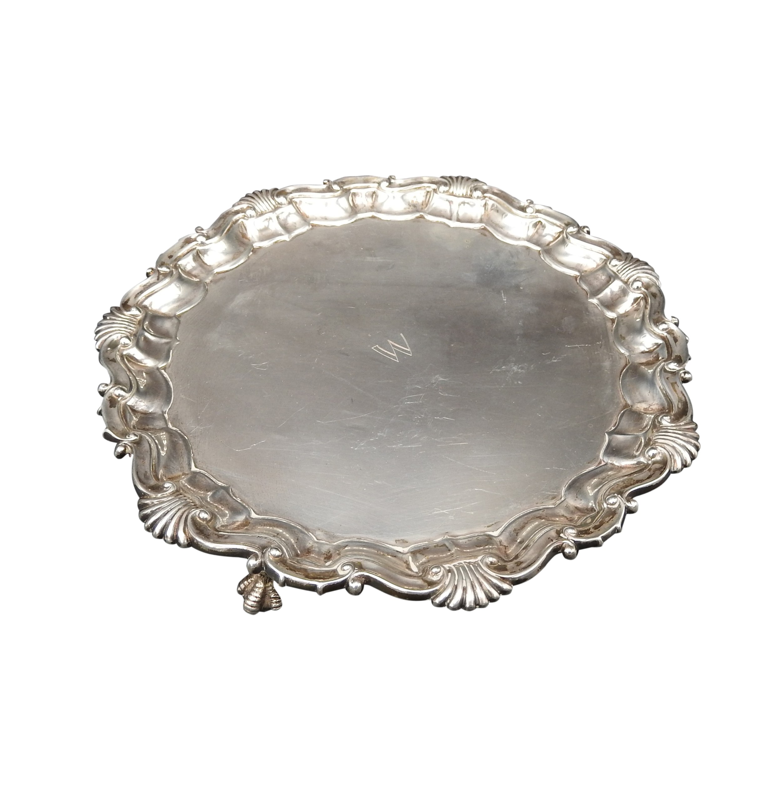 A SILVER SALVER, with Acanthus shell-scroll border, on three claw feet, London 1889, maker's stamp