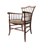 A 19TH CENTURY RUSH SEAT ELBOW CHAIR, with a serpentine top rail supported by turned spindles, on