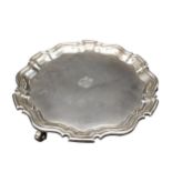 A SILVER SALVER, with scroll work edge, on three scroll feet, London 1911, maker's stamp H & A.S,