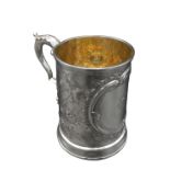 A VICTORIAN SILVER TANKARD WITH FLORAL REPOUSSE DECORATION, by William Brown & William Nathaniel