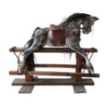 A VINTAGE PAINTED PINE NURSERY ROCKING HORSE, with a dappled grey finish, on a trestle base, 110 x